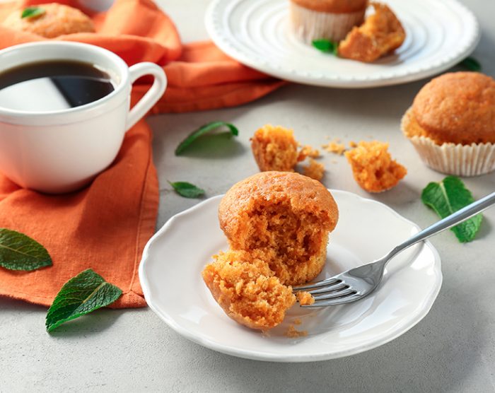 Plate with delicious carrot muffin on table
